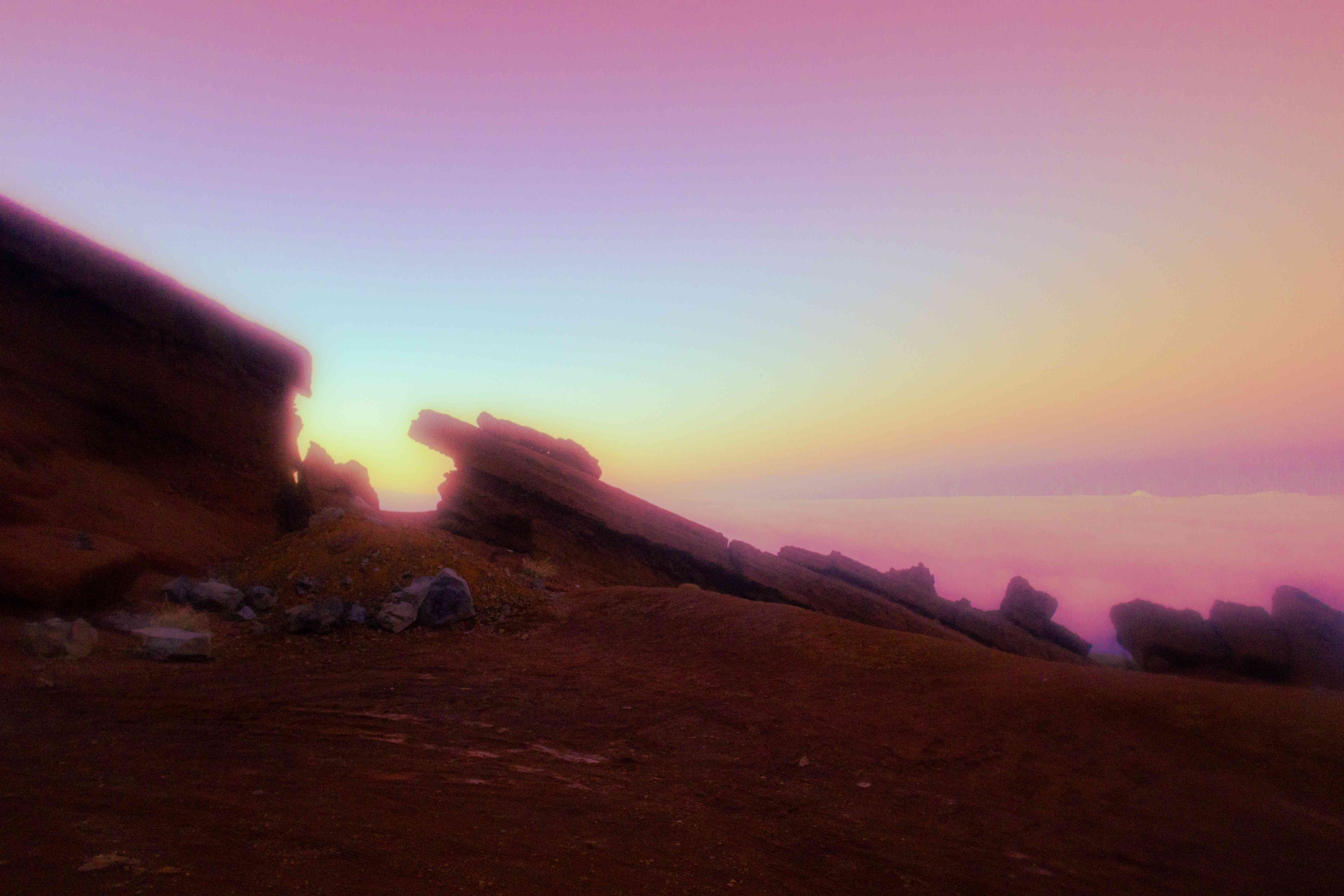 Pink and purple sunset over volcanic rock slabs